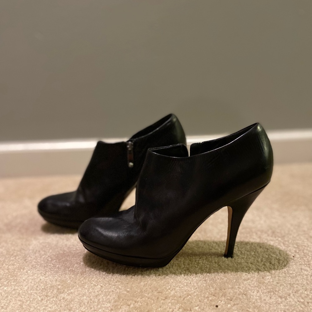 Black leather heeled booties, perfect for night out or formal event.